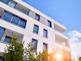 building-with-blue-sky-trees-background