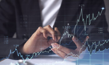 A woman financial trader in formal wear is checking the phone to sign the contract to invest money in stock market. Internet trading and wealth management concept. Forex hologram chart.